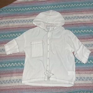 White short-sleeved hooded blouse with black contrast stitching